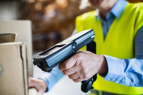 Warehouse woman worker with barcode scanner. Stock Photos
