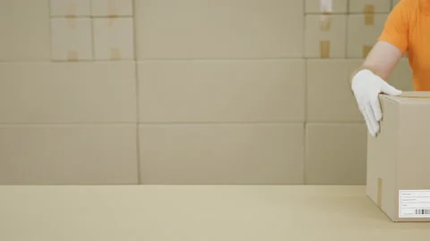 Warehouse worker and big box with PRODUCT OF UKRAINE printed text Stock Footage 136029153