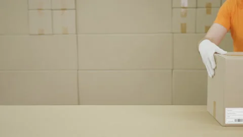 Warehouse worker and big box with PRODUCT OF PANAMA printed text Stock Footage 136029458