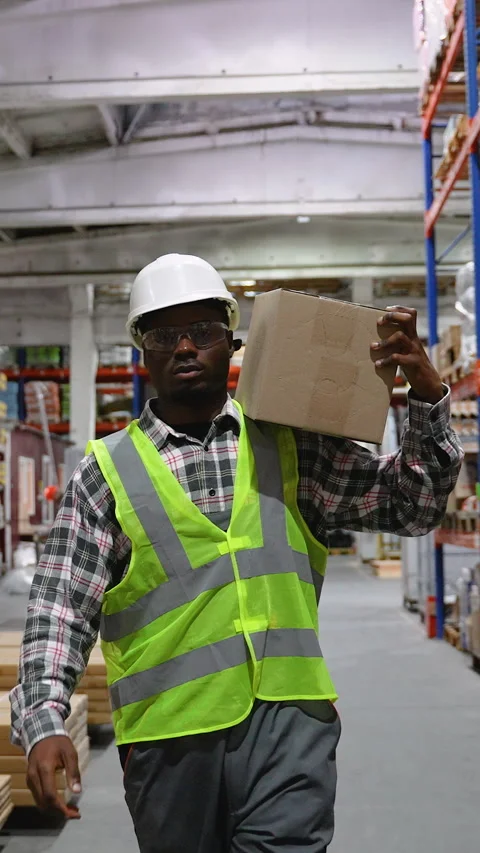 Warehouse Worker Carrying Box Through Storage Facility Video stock 294269028