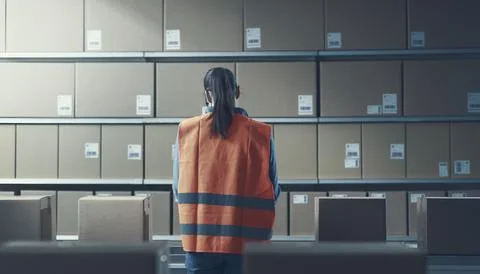 Warehouse worker checking boxes on the conveyor belt Stock Photos