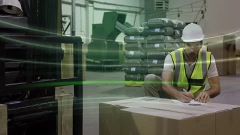 Warehouse worker checking documents on box, green data processing animation over Stock Footage 305017158