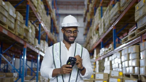 Warehouse worker checking the package with a barcode scanner in warehouse Stock Footage 163345923
