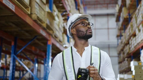 Warehouse worker checking the package with a barcode scanner in warehouse Stock Footage 163346089