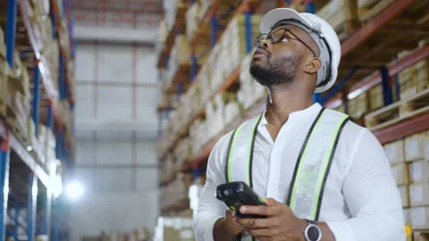 Warehouse worker checking the package with a barcode scanner in warehouse Stock Footage 163348118