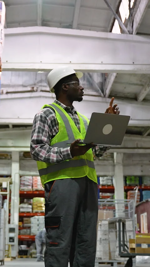 Warehouse Worker checking stock with laptop in Logistic center Stock Footage 294268093