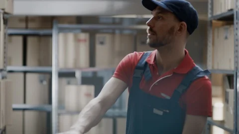 Warehouse Worker Collects Order by Taking Cardboard Boxes and Parcels of Shelf Stock Footage 96142600