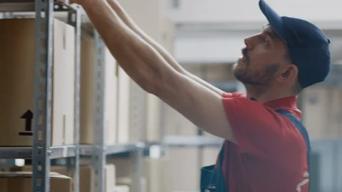 Warehouse Worker Collects Order by Taking Cardboard Boxes and Parcels of Shelf Stock Footage 96142730