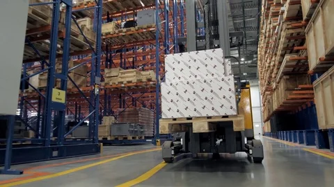 Warehouse worker driver in uniform loading cardboard boxes by forklift stacker Stock-Footage 81589657