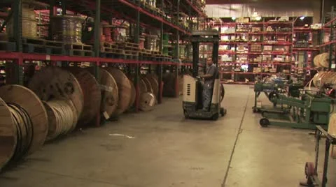 Warehouse Worker Driving a Forklift Through A Construction Supply Warehouse 스톡 동영상 18963998