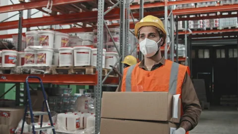 Warehouse Worker in Face Mask Carrying Boxes Stock Footage 159120039