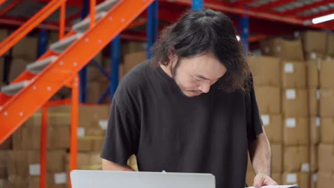 Warehouse Worker Focused on Laptop Task. Stock Footage 278431323