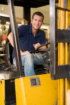Warehouse worker in forklift Stock Photos