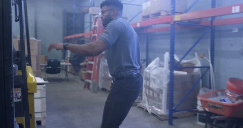 Warehouse worker getting inside a forklift in warehouse Stock Footage 116366537