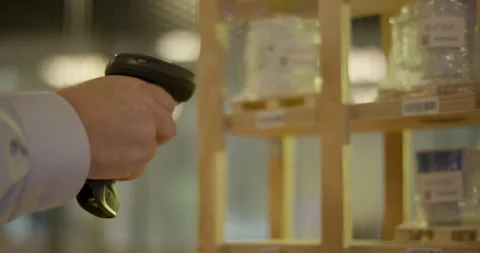 Warehouse worker hand using wireless barcode scanner for inventory management Stockbeeldmateriaal 329674273