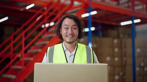 Warehouse Worker Holding Box in Storage Facility. Stock Footage 278428021