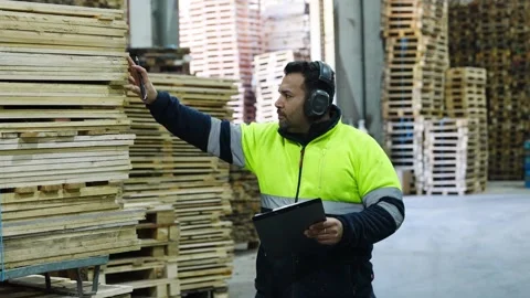 Warehouse worker inspecting pallets in slow motion Stock Footage 313917982