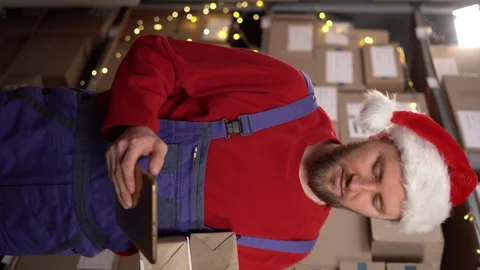 Warehouse worker, inventory manager uses digital tablet while checking parcels Stock Footage 248145906