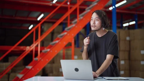 Warehouse Worker with Laptop Analyzing Stock. Video stock 277744007