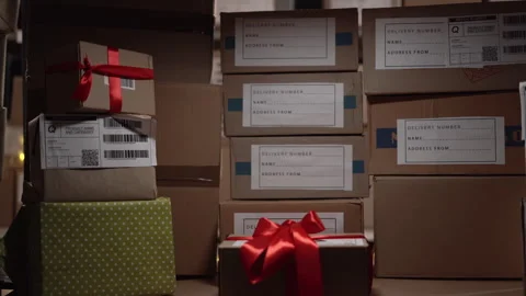 Warehouse worker looking for a parcel on the shelves full of boxes with things Stock Footage 247993728