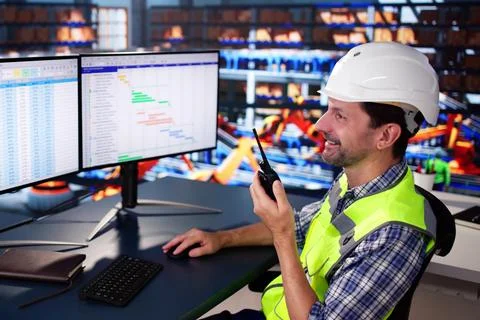 Warehouse Worker Manager Using Computer And Walkie-Talkie Stock Photos