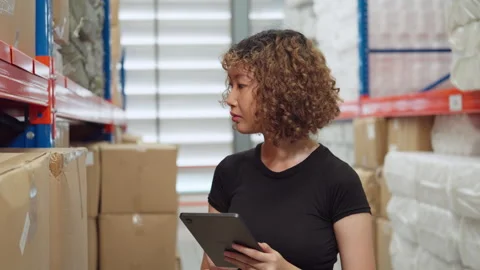Warehouse Worker Managing Inventory on Tablet. Stock Footage 278430411