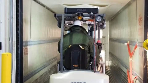 Warehouse worker. Moving palette of boxes with forklift onto truck A Video stock 101976316