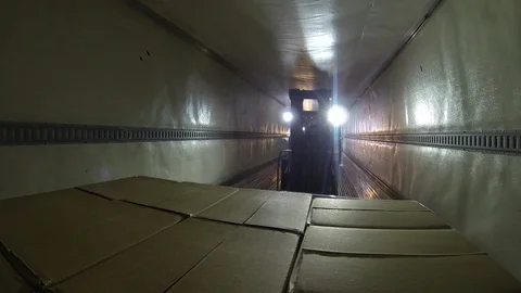 Warehouse worker. Moving palette of boxes with forklift onto truck. pov Stock Footage 101976324