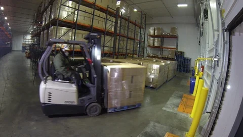 Warehouse worker. Moving palette of boxes with forklift. wide angle Stock Footage 102185793