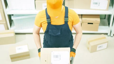 Warehouse worker or courier holds a damaged parcel Stock Footage 145879281