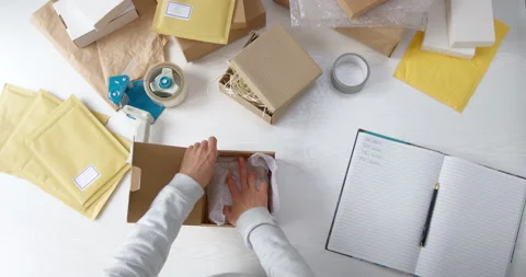 The warehouse worker packs the goods in a box for delivery by courier service. Video stock 166515540