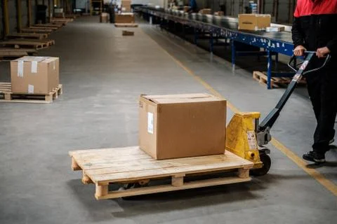 Warehouse worker with a pallet rack Photos