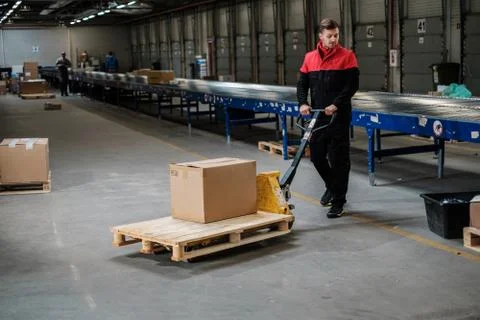 Warehouse worker with a pallet rack Stock Photos