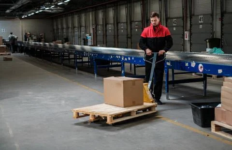 Warehouse worker with a pallet rack Photos