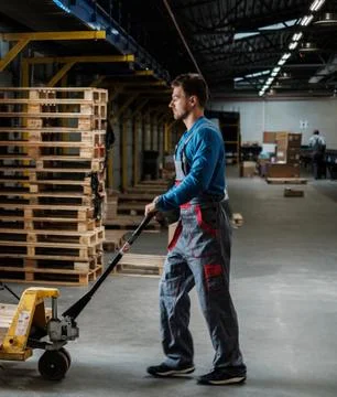 Warehouse worker with a pallet rack Stock Photos