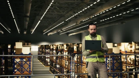 Warehouse worker performing logistics and order fulfillment tasks Stock Footage 330442111