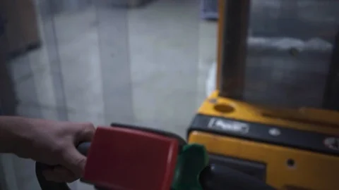 Warehouse Worker Pulling Forklift Cart to Move Stock to the Storage Facility 動画素材 118725506