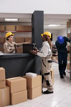 Warehouse worker putting customer order on counter for scanning 스톡 사진