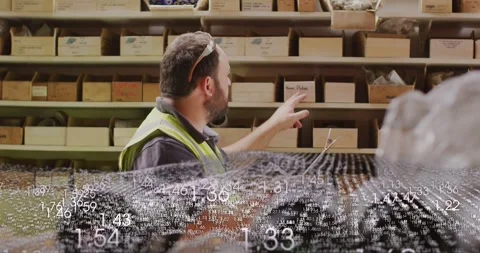 Warehouse worker reading tablet, pointing, counting bins for stock while point Stock Footage 331006232