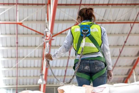 Warehouse worker with safety harness secuerity for fall protection Stock Photos