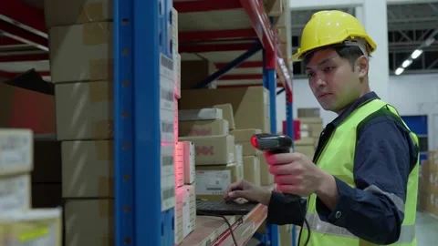 Warehouse worker scan box goods in inventory and check stock product. Transpo Stock Footage 220434556