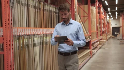 Warehouse worker scan goods in inventory in a hardware store and check stock Stock Footage 321613867