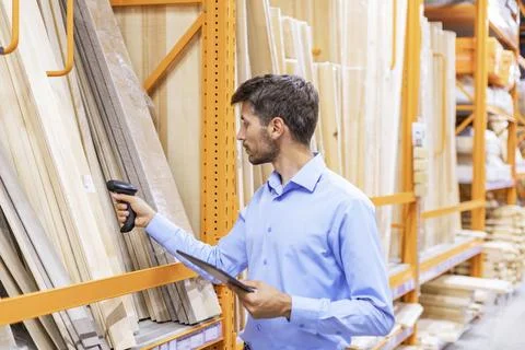 Warehouse worker scan goods in inventory in a hardware store and check stock  Stock Photos