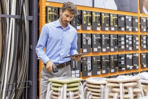 Warehouse worker scan goods in inventory in a hardware store and check stock  Stock Photos
