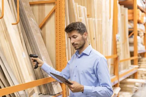 Warehouse worker scan goods in inventory in a hardware store and check stoc.. Stock Photos