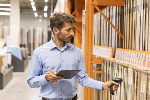 Warehouse worker scan goods in inventory in a hardware store and check stoc.. Stock Photos