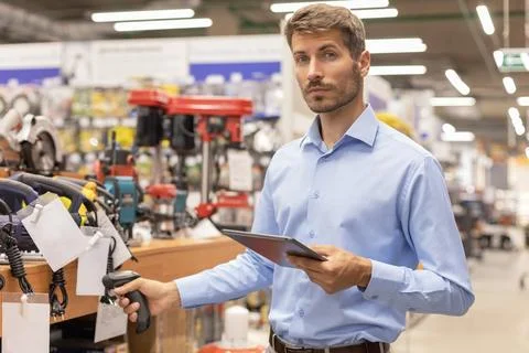 Warehouse worker scan goods in inventory in a hardware store and check stoc.. Stock Photos