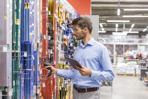Warehouse worker scan goods in inventory in a hardware store and check stoc.. Stock Photos