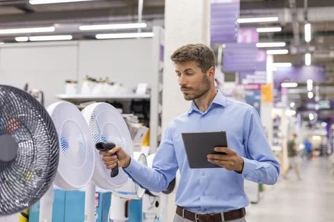 Warehouse worker scan goods in inventory in a hardware store and check stoc.. Stock Photos