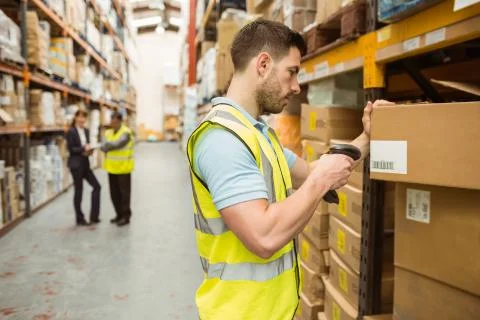 Warehouse worker scanning barcode on box Stock Photos